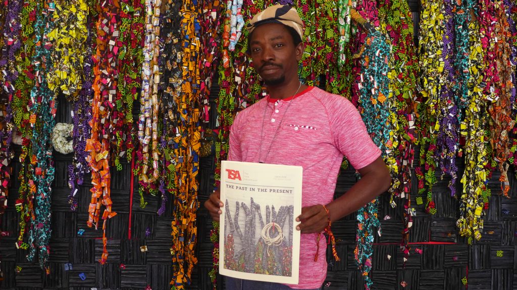 Olanrewaju Tejuoso in front of the installation "Oldies and Goodies", Palais de Justice. Photo Credit: The Sole Adventurer. 