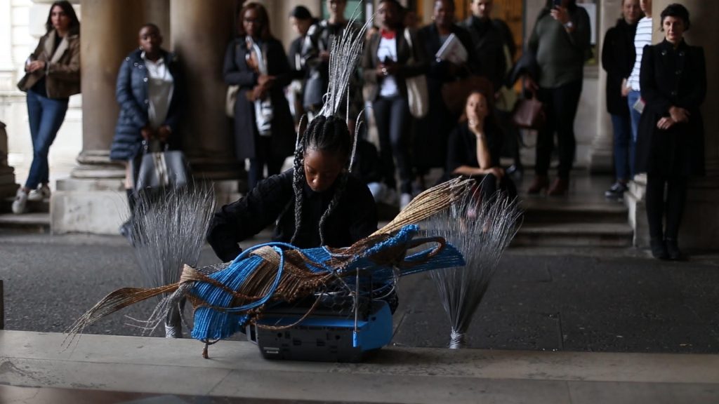 Adejoke Tugbiyele, Shifting The Waves: The mask, The Boat, The Broom, The Box, 2017. Image from the performance at 1:54 Contemporary Art Fair, London. Image copyright Ade Odetola, courtesy the artist. 