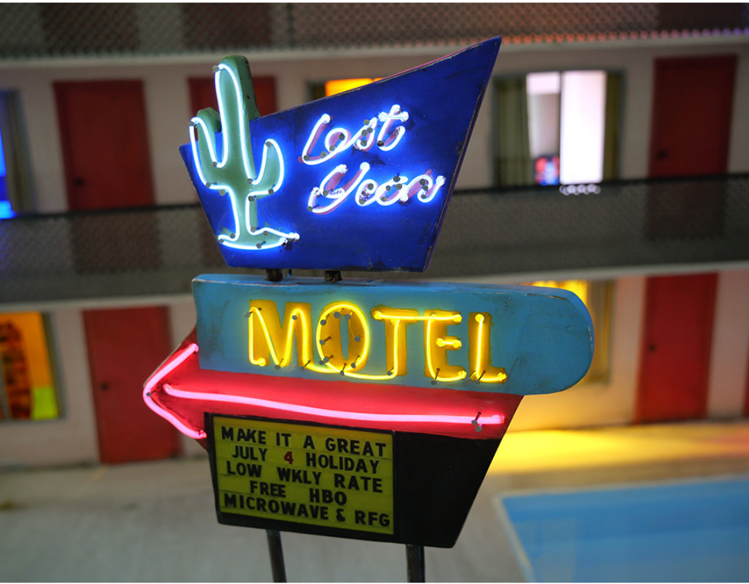 "Lost Year Motel" (2020) by 2020 Foundwork Artist Prize Honoree Tracey Snelling. Wood, plaster, paint, metal, lights, fabric, lcd screens, media players, electroluminescent wire, water, speakers, transformer. 24 x 50 x 24 in.